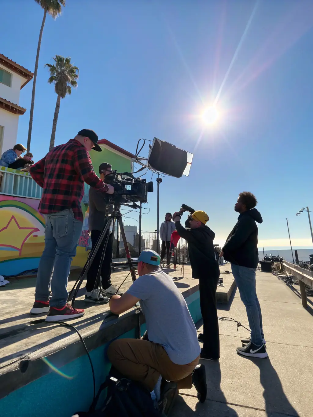 A scene from a community-based film project, showing local residents actively involved in the production process, emphasizing the collaborative nature of the initiative.