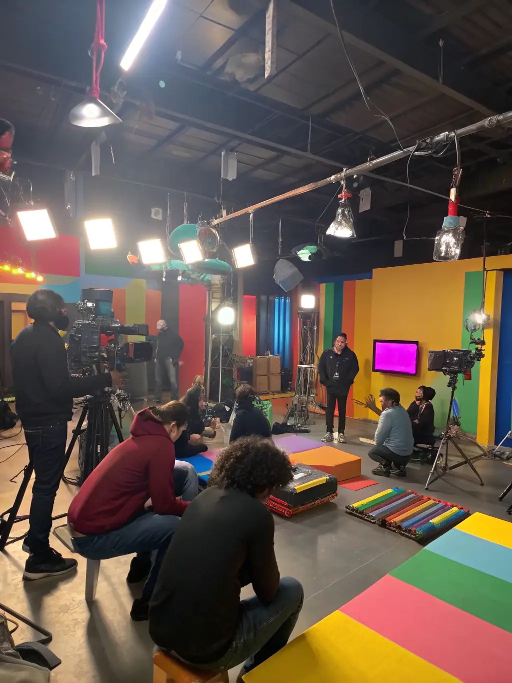 Participants collaborating on an analog film project, using vintage cameras and equipment, emphasizing the tactile and artistic aspects of traditional filmmaking.
